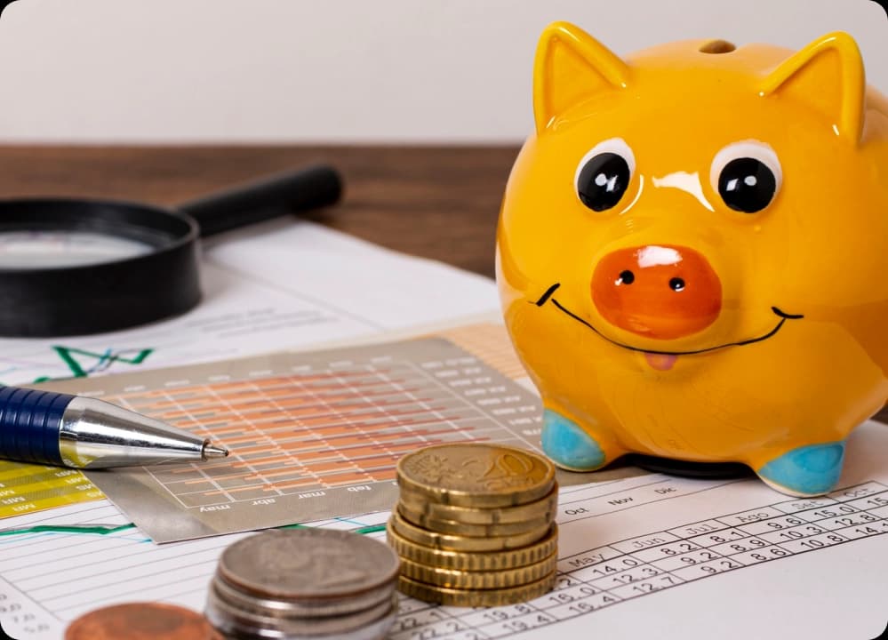 Financial planning tools with piggy bank, charts, coins, and calculator on desk