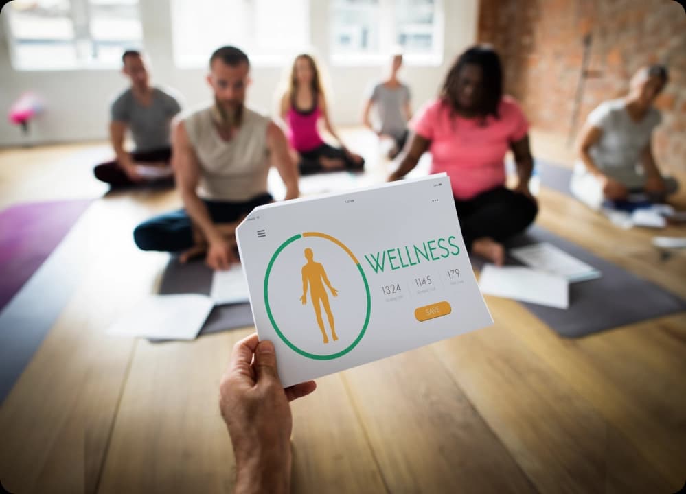 Group fitness class with wellness tracking sheet in foreground
