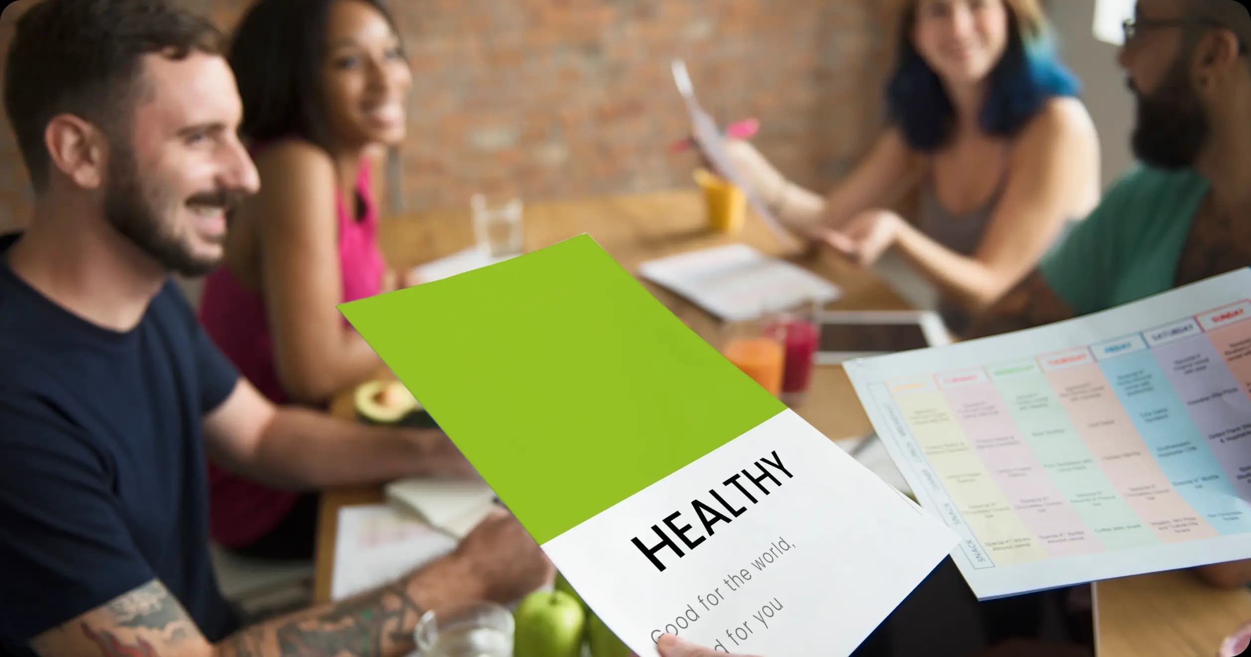 Team discussing healthy lifestyle materials during a corporate wellness planning session